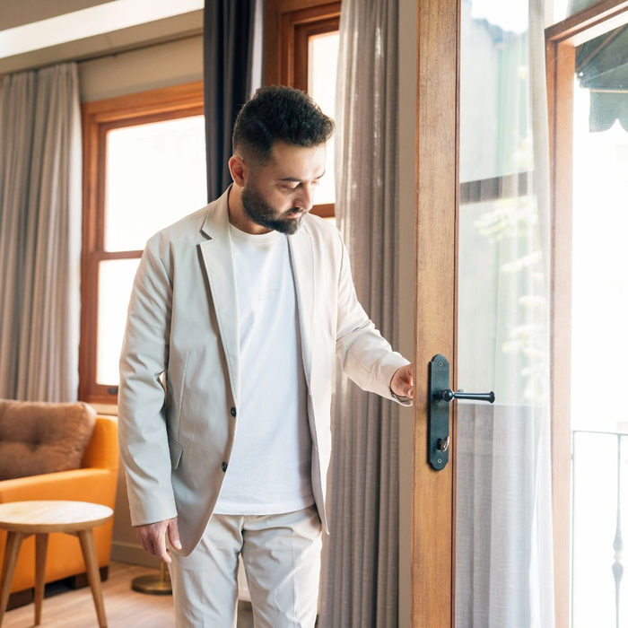 man looking at door of home