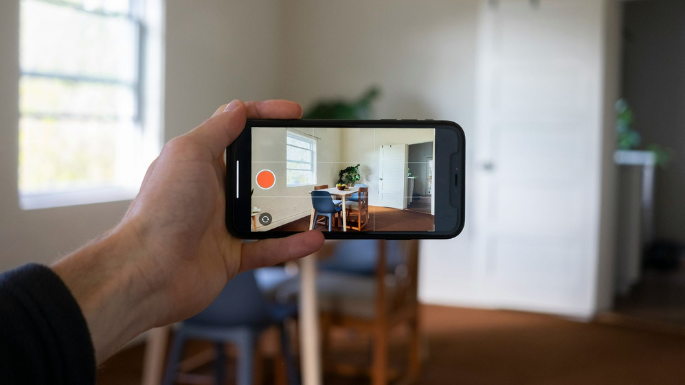 person taking photo of home