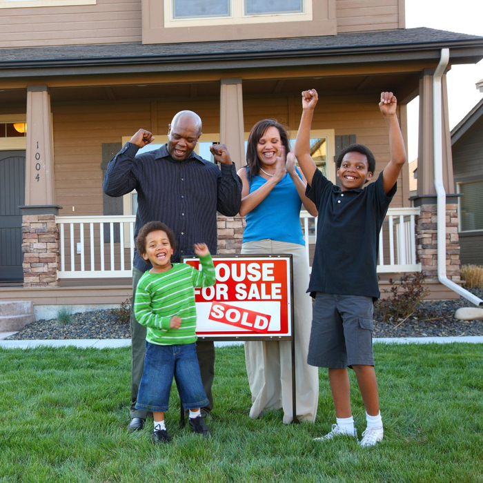 family in front of new house