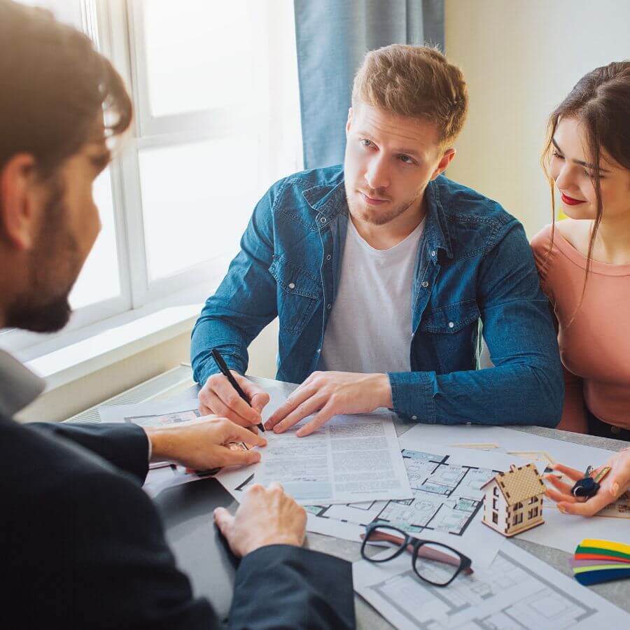 couple signing home-buying paperwork