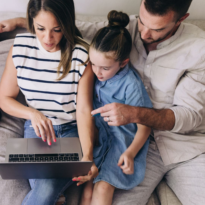 family looking at laptop