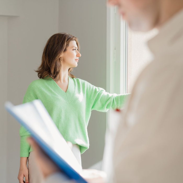 woman looking at window with inspector