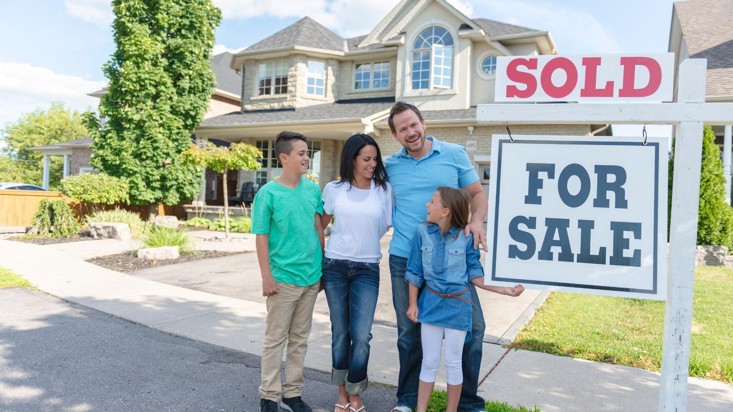 family in front of new house