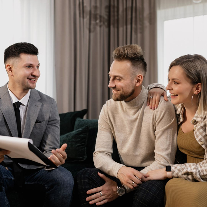 couple speaking with real estate professional