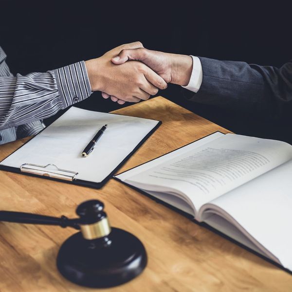 Lawyer and judge shaking hands. Lawyer and judge shaking hands.