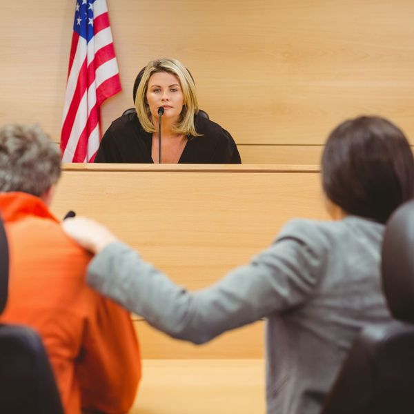 Defendant, lawyer, and judge in court. Defendant, lawyer, and judge in court.