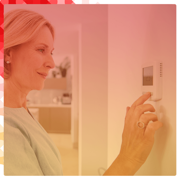 A woman touching thermostat