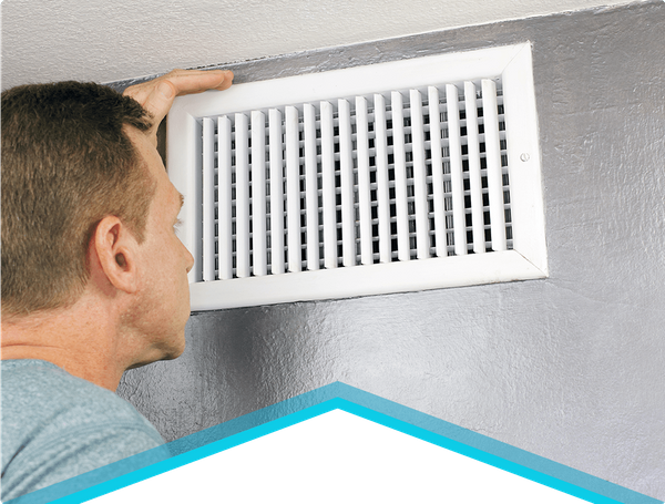 A man investigating the heater on wall