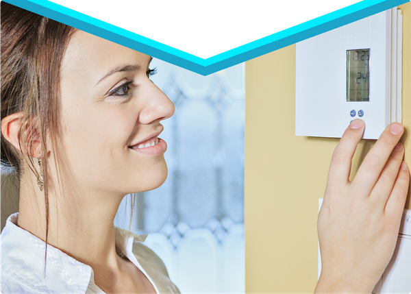 woman adjusting thermostat