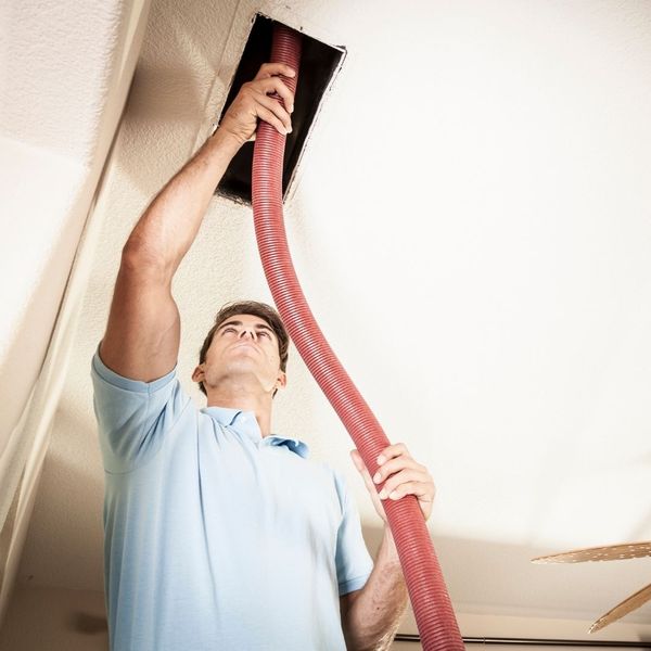 HVAC tech cleaning duct