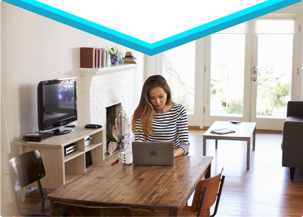 A girl at her computer in her home