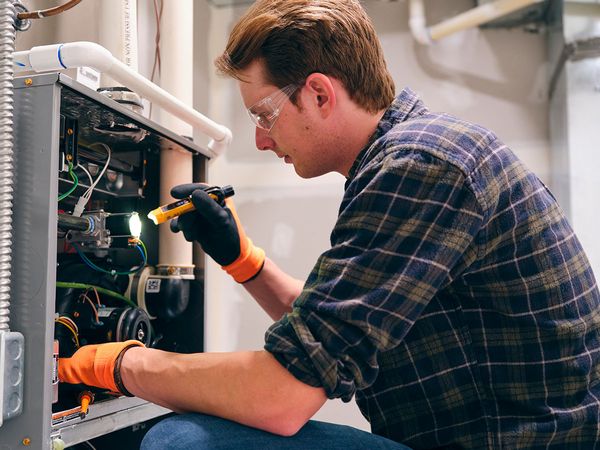 Image of a technician working on a furnace