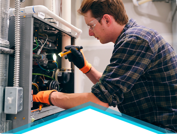 technician repairing furnace