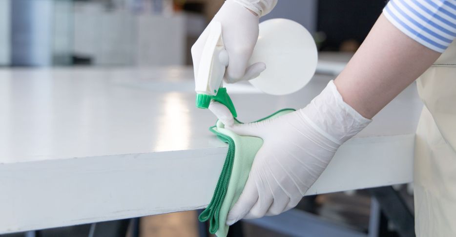 professional cleaner disinfecting surfaces
