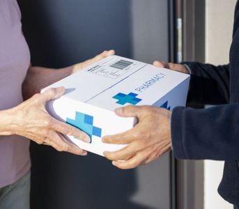handing over a delivery box of prescriptions