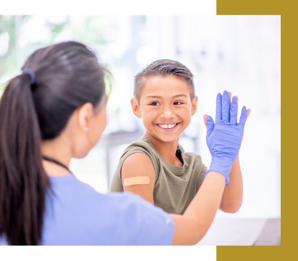 woman high-fiving a child who just got an immunization