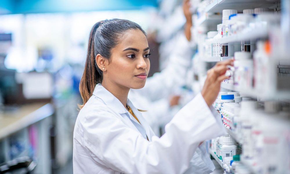 pharmacist looking at contents on shelf