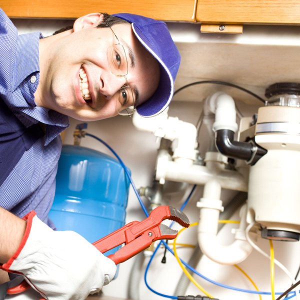 Plumber smiles at camera before repair