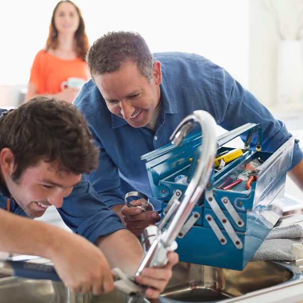 plumbers working on sink