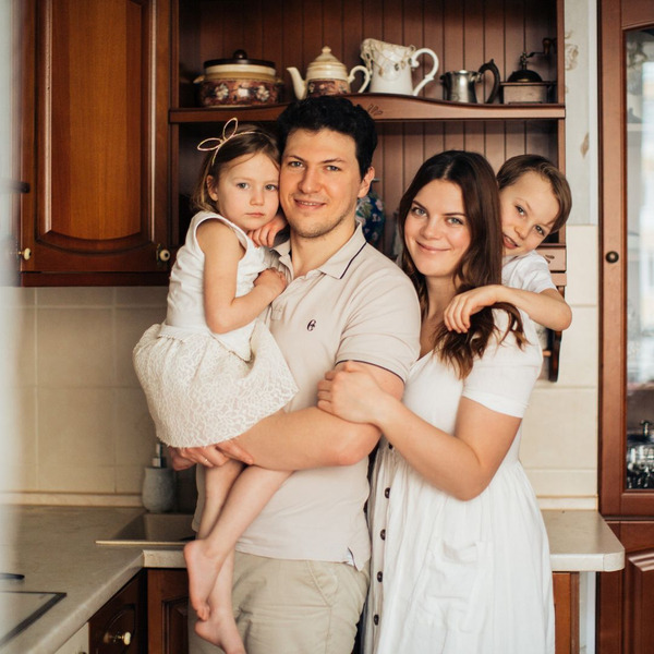 A happy family posing in their kitchen