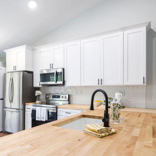 kitchen with a work triangle, a sink, oven, and fridge kitchen with a work triangle, a sink, oven, and fridge