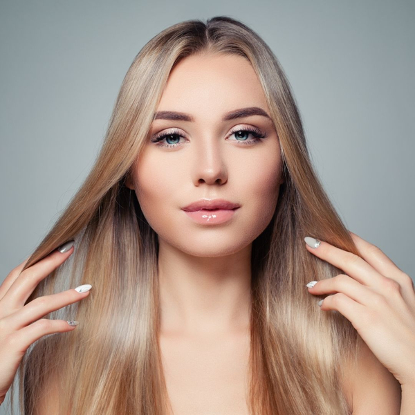Woman showing off long, straight, healthy blonde hair.