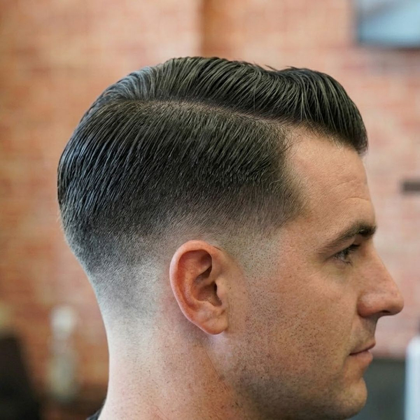 Close-up of a sharp, professional men's fade haircut showcasing precision grooming.