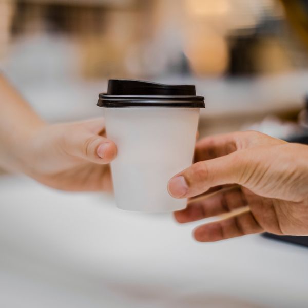 Handing a cup of coffee