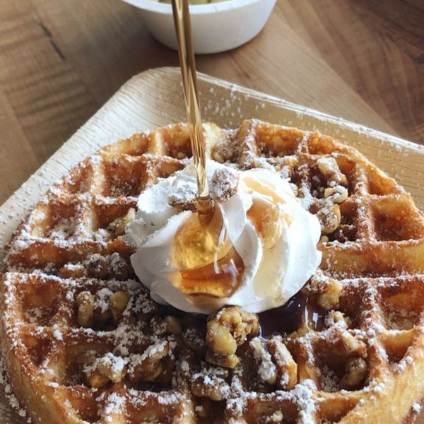 waffle with syrup being poured on it