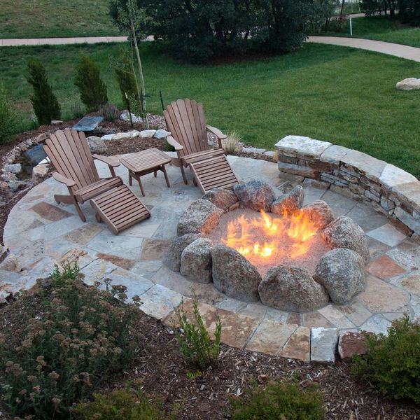 sitting area next to a firepit on a stone patio