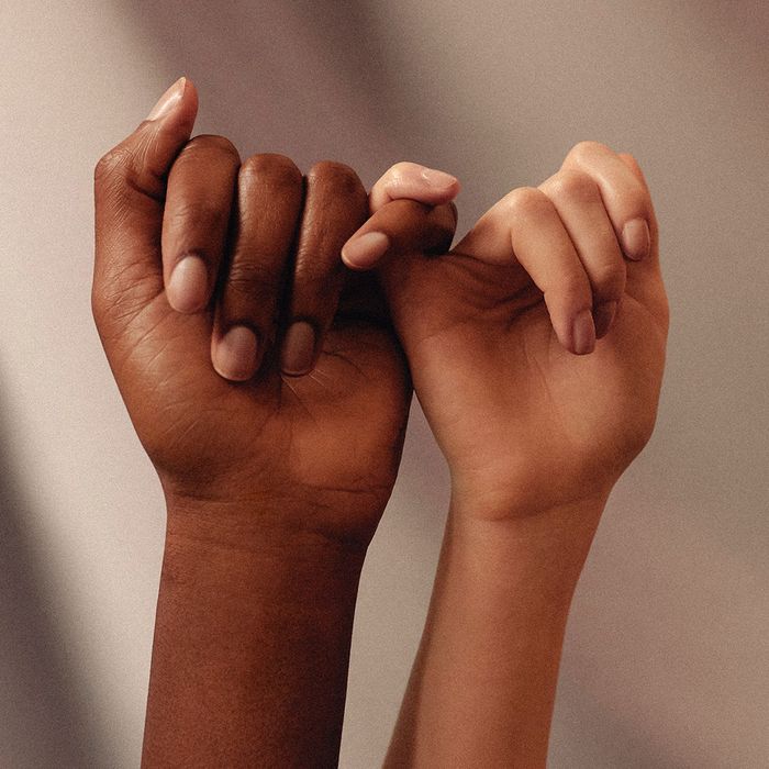 image of two people’s hands linking pinkies 