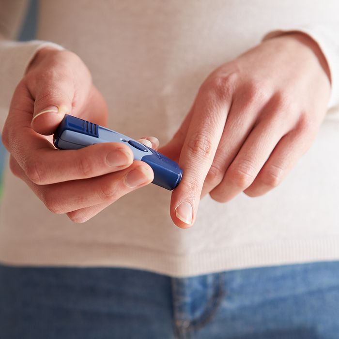 Woman checking her blood sugar levels