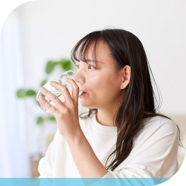 woman drinking clean water from glass