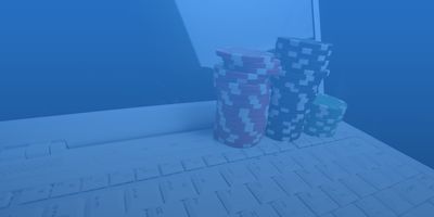Gambling chips on a white laptop computer. 