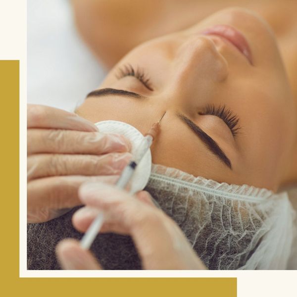 carefully injecting small needle to patient's brow