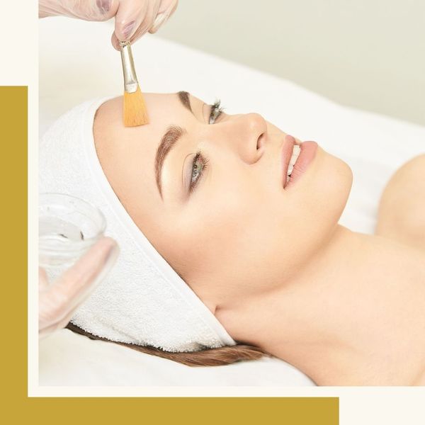brushing chemical peel onto patient's forehead