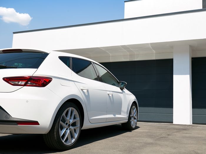 Image of a car parked outside of a home garage.