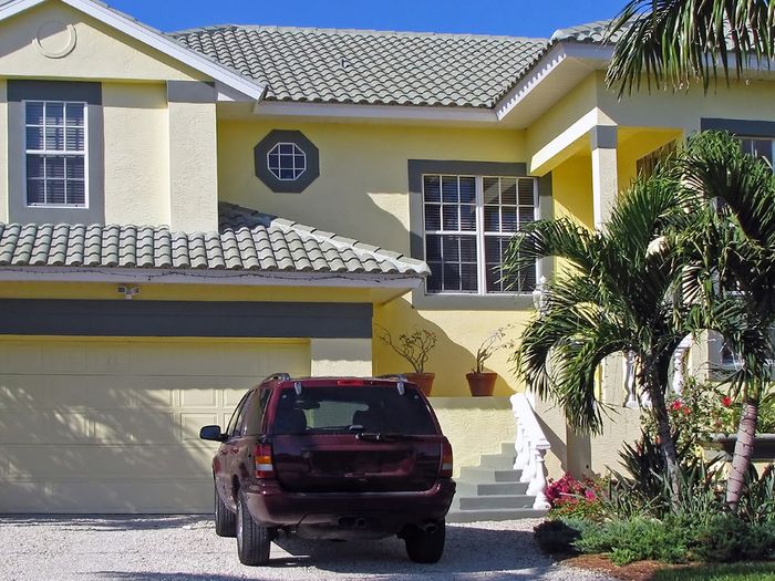 Car sitting in the driveway of a home.