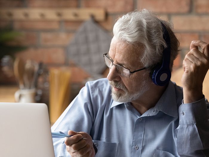 Man using a laptop and working.