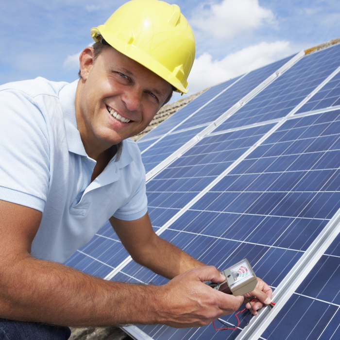 smiling contractor installing solar panels