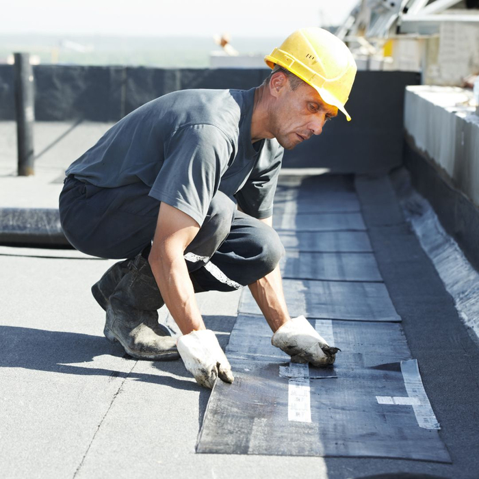 man inspecting and installing a commercial roof
