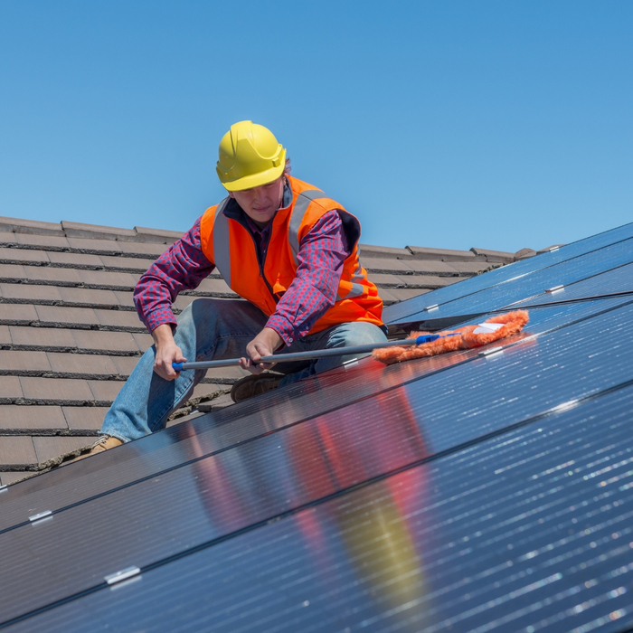 Woman cleaning solar panels