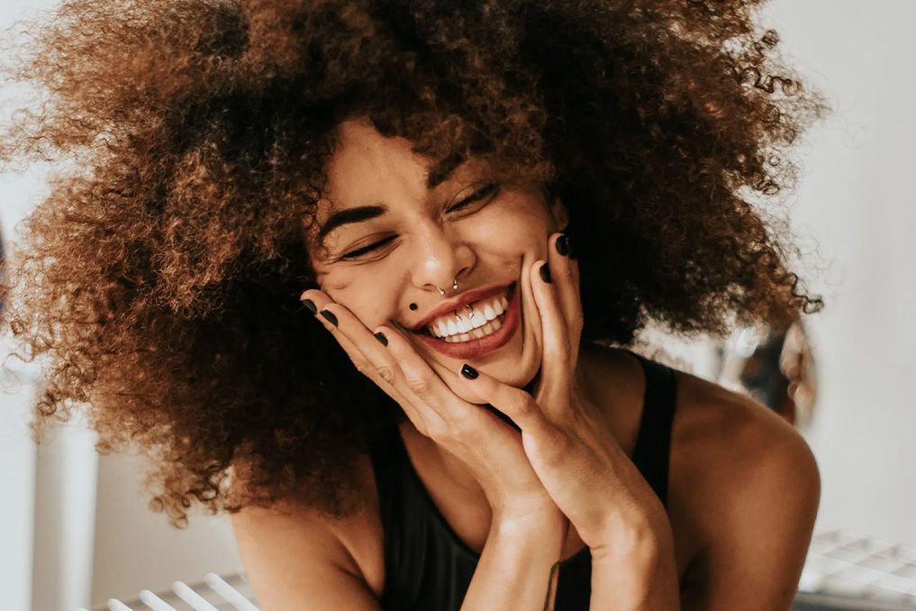 woman with big hair and a big smile