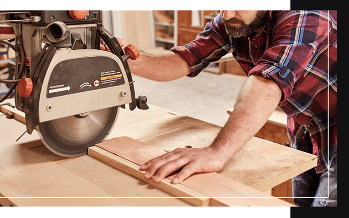 image of a man cutting wood