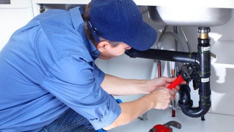 residential plumber working on a drain