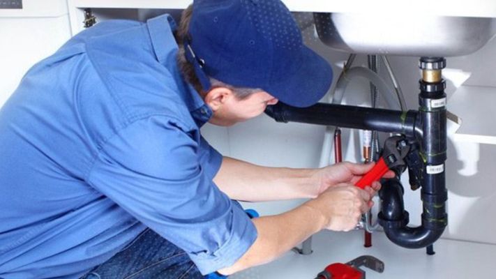 residential plumber working on a drain