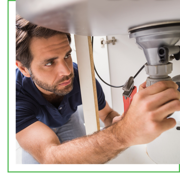 plumber working under sink