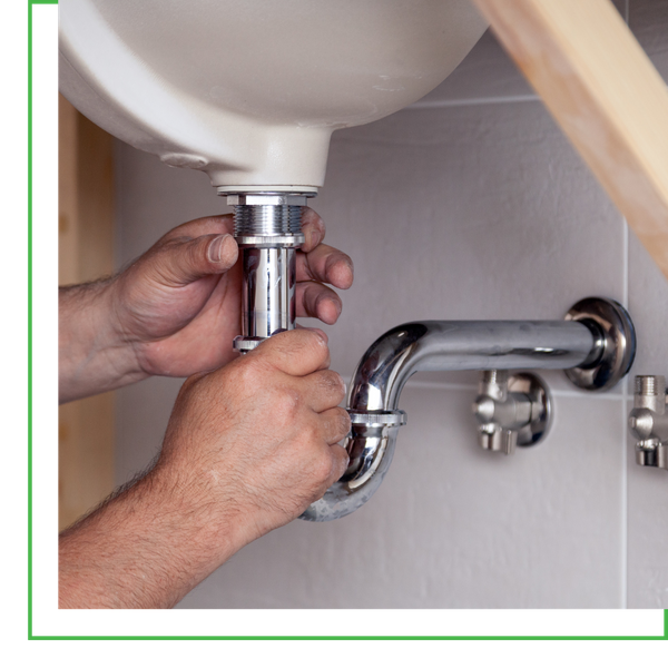 plumber working under sink