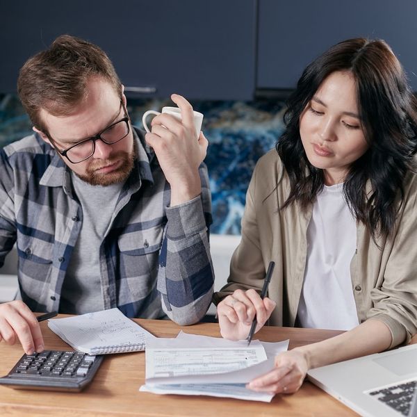 confused couple looking at a water bill