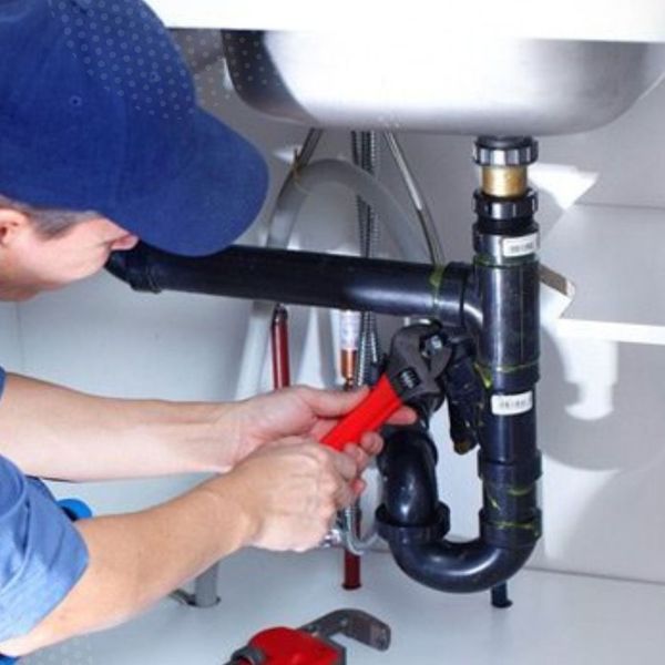 plumber working on drain pipes plumber working on drain pipes